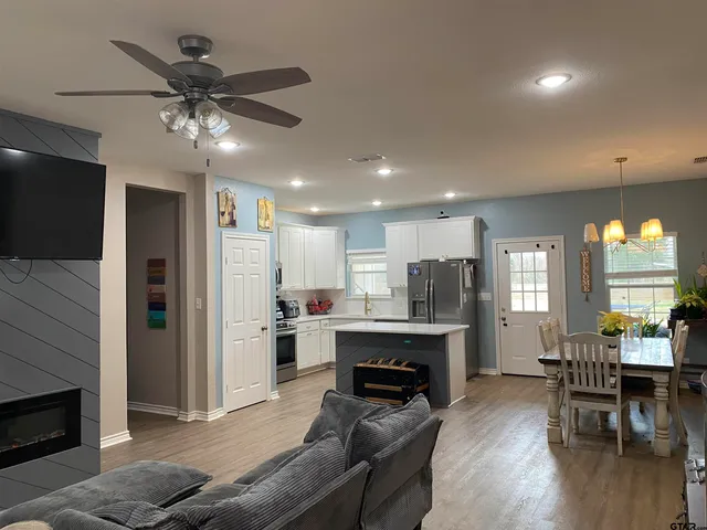 a living room with furniture a fireplace and a flat screen tv