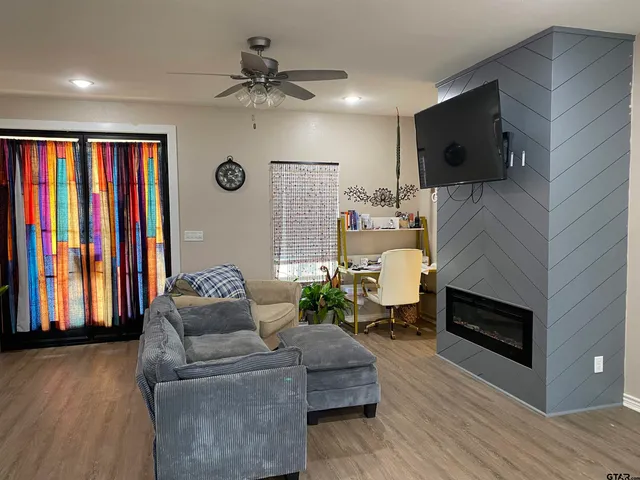 a living room with furniture and a flat screen tv