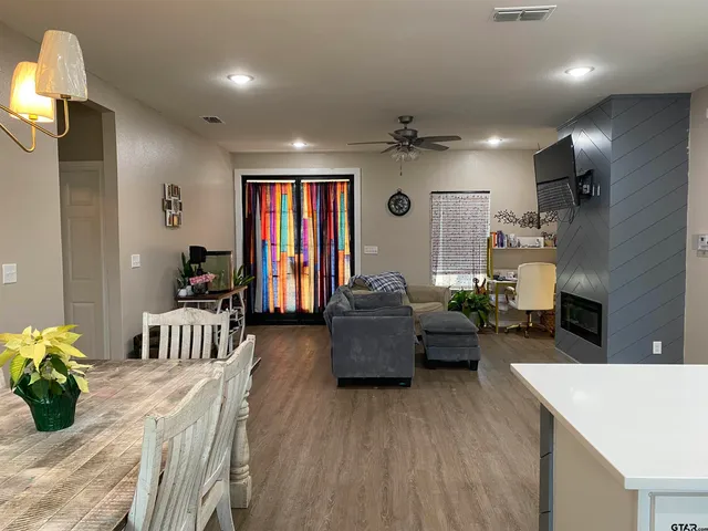 a living room with furniture and a wooden floor