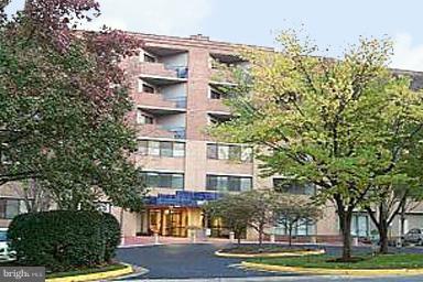 1951 Sagewood Lane, Unit 6 Reston, VA 20191 - Photo 1 of 30 a front view of a building with trees