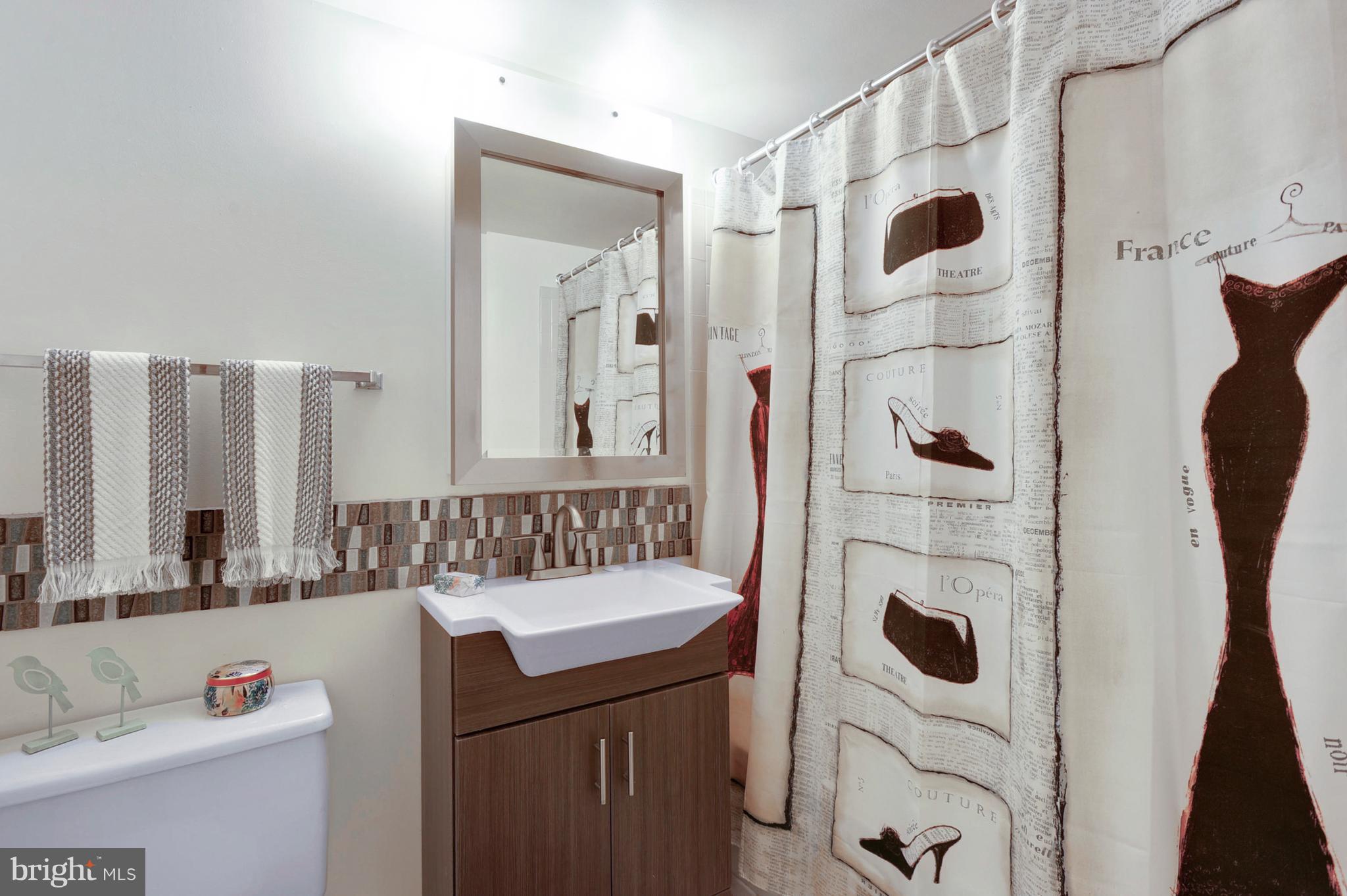 1951 Sagewood Lane, Unit 6 Reston, VA 20191 - Photo 13 of 30 a bathroom with a sink and mirror