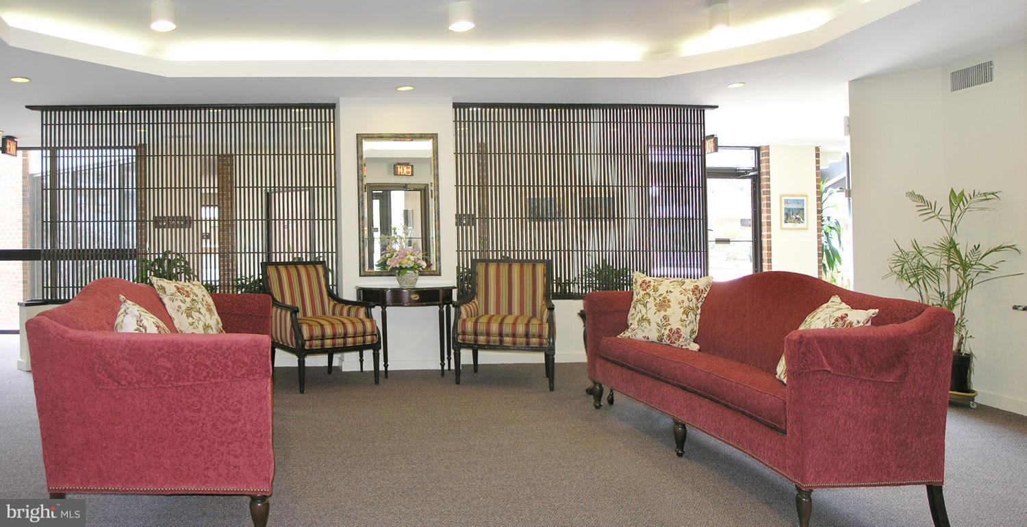 1951 Sagewood Lane, Unit 6 Reston, VA 20191 - Photo 3 of 30 a living room with furniture and a potted plant