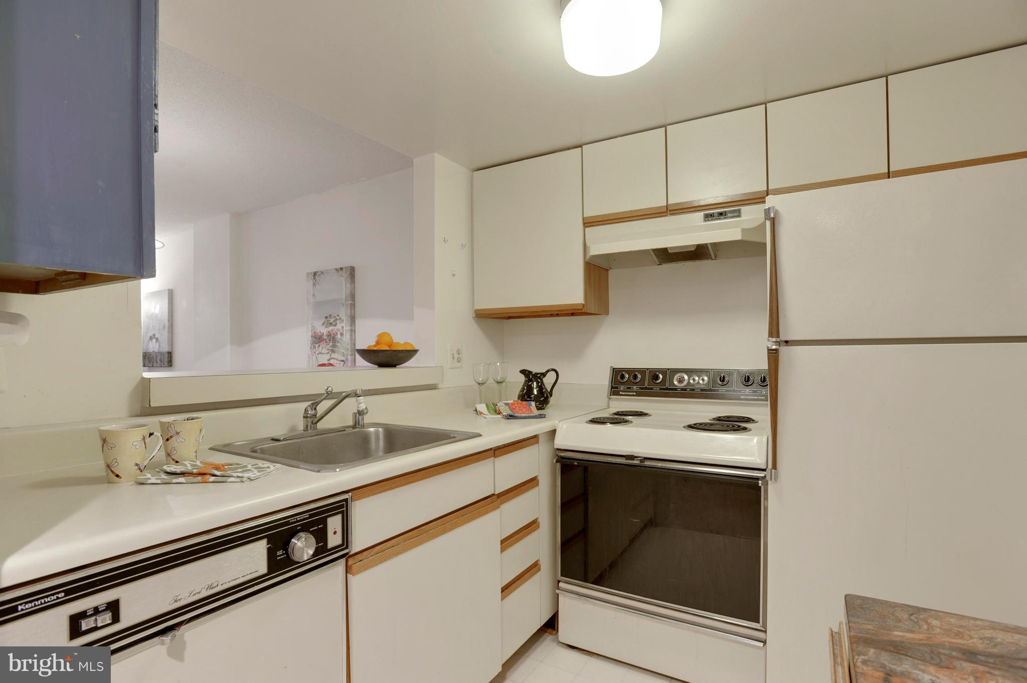 1951 Sagewood Lane, Unit 6 Reston, VA 20191 - Photo 9 of 30 a kitchen with a sink stove and refrigerator