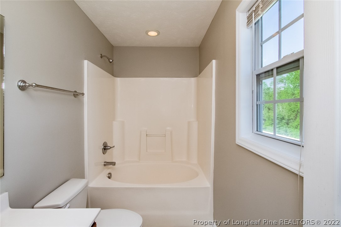 147 Boston Harbor Cameron, NC 28326 - Photo 17 of 27 a bathroom with a bathtub and a shower