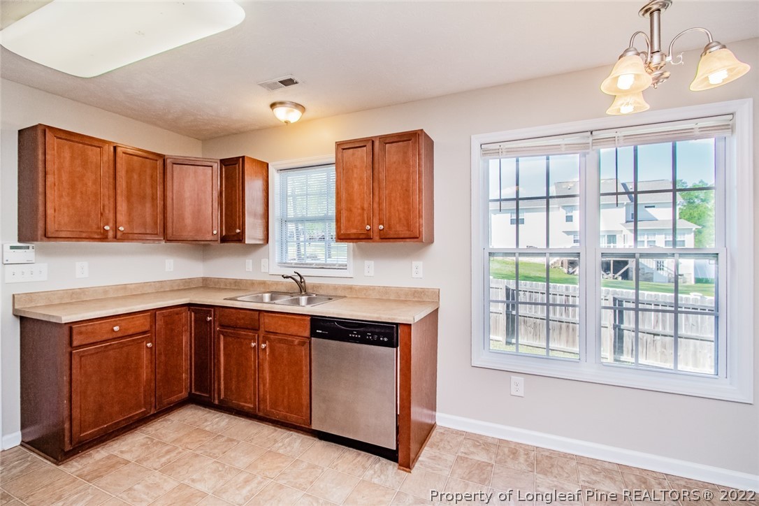 147 Boston Harbor Cameron, NC 28326 - Photo 7 of 27 a kitchen with a sink cabinets appliances and a window