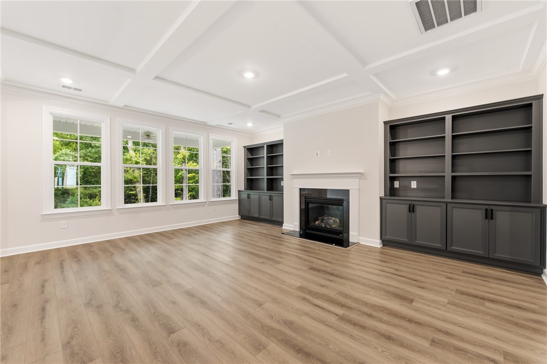 705 Weathered Oak Way Anderson, SC 29621 - Photo 19 of 47 This living area features a charming fireplace and built-in shelving, complemented by a gorgeous ceiling design.