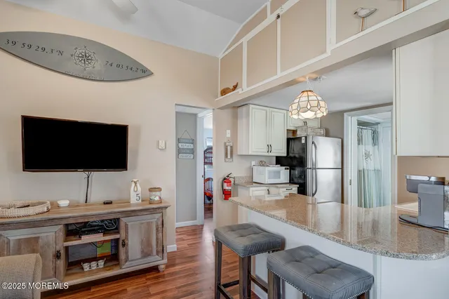 a view of a livingroom with furniture and a flat screen tv
