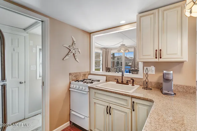 a kitchen with a sink stove and cabinets