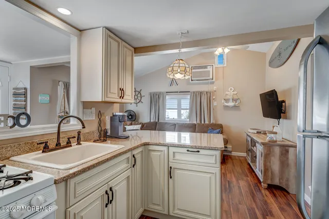 a kitchen with a sink cabinets and wooden floor