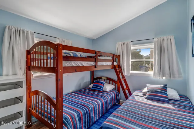 a bedroom with two beds and a window