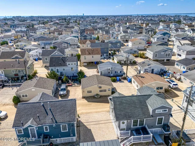 an aerial view of multiple houses with a yard
