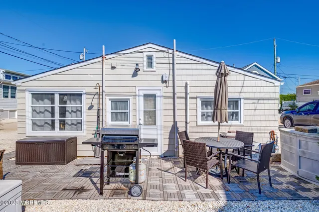 a backyard of a house with table and chairs