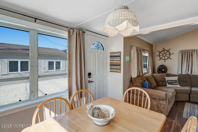 a living room with furniture a table and a chandelier