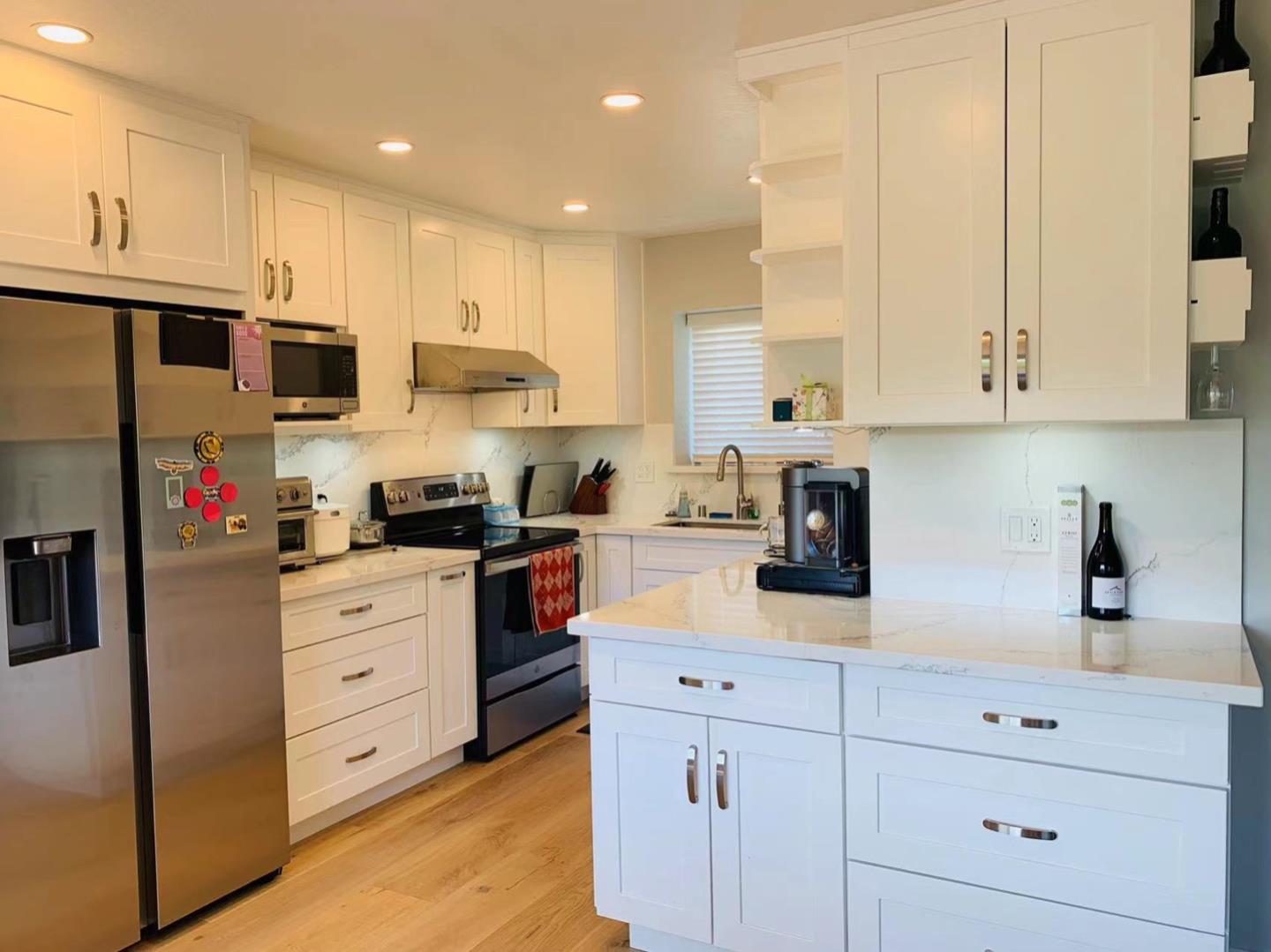 3513 Hillcrest Drive Belmont, CA 94002 - Photo 2 of 18 a kitchen with stainless steel appliances granite countertop white cabinets sink and refrigerator