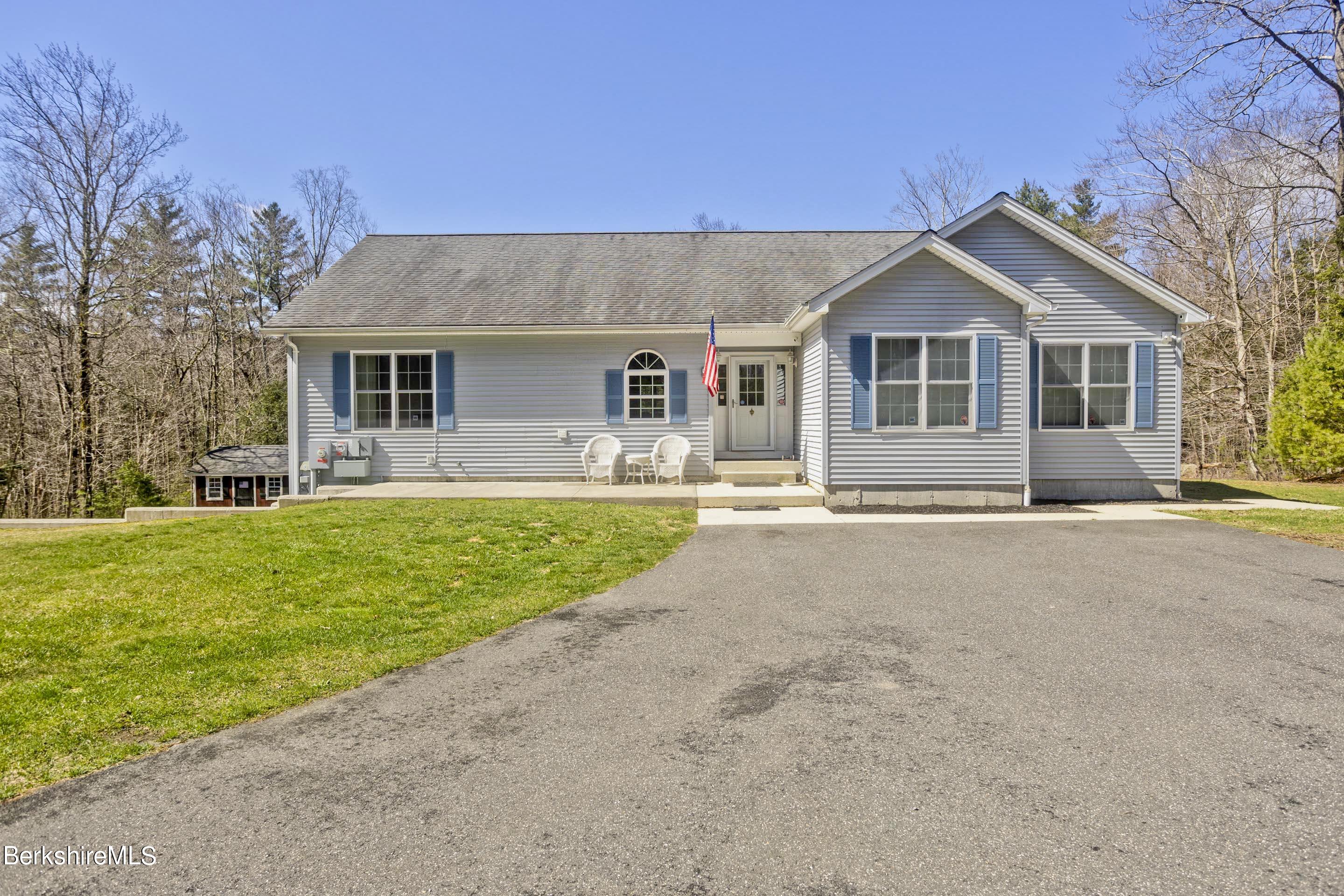 495 West Center Road Otis, MA 01253 - Photo 2 of 46 a front view of house with yard and green space