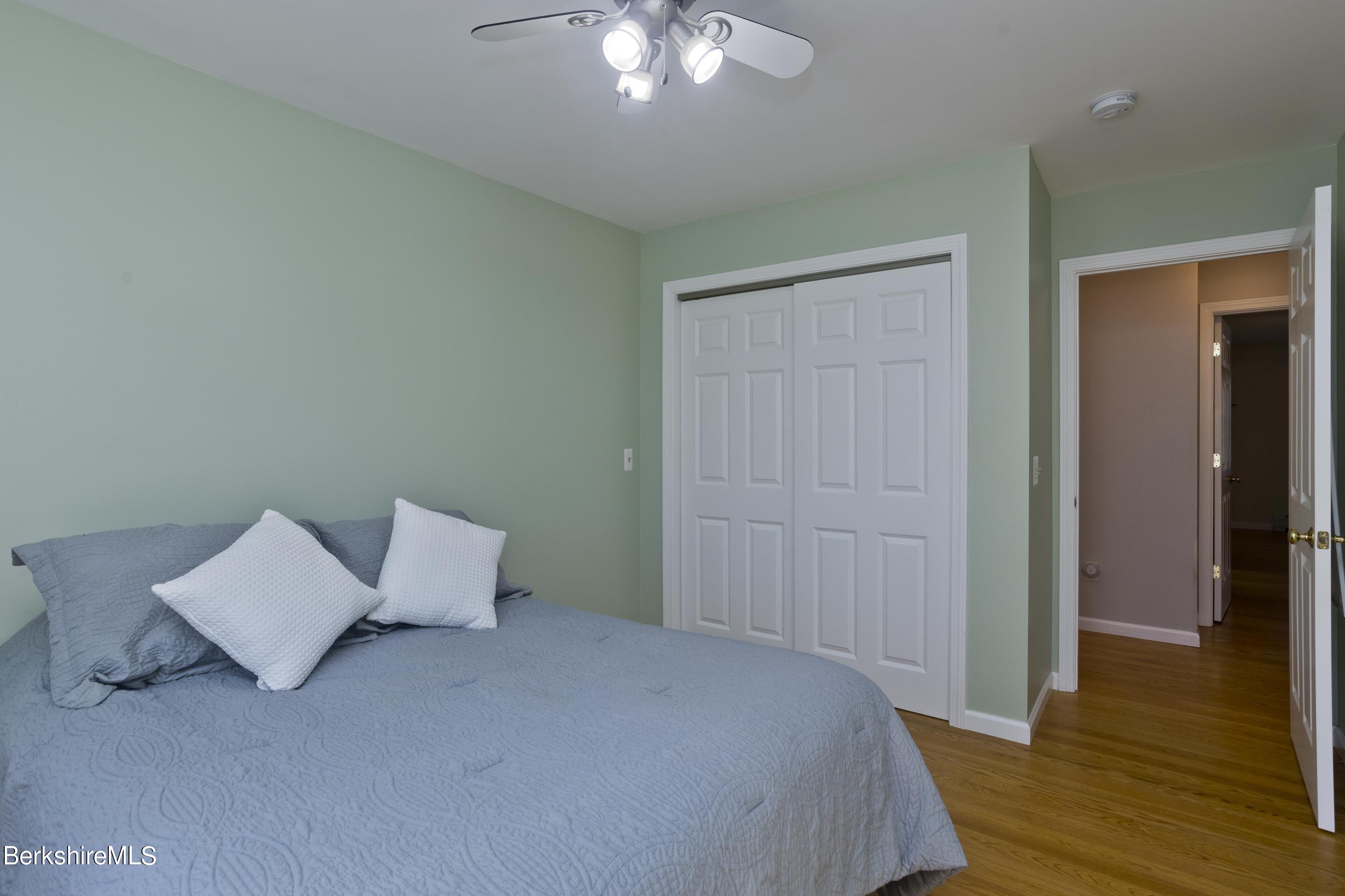 495 West Center Road Otis, MA 01253 - Photo 30 of 46 a bed room with a bed and a lamp
