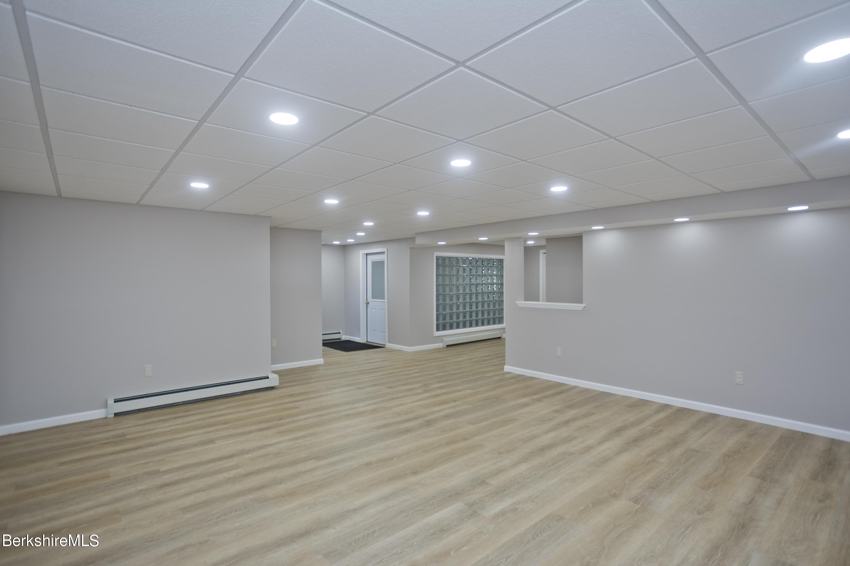 495 West Center Road Otis, MA 01253 - Photo 35 of 46 an empty room with wooden floor and windows
