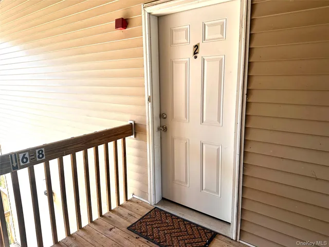 a view of a balcony with wooden floor and door