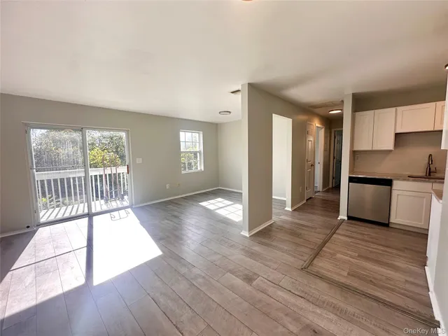 a balcony with wooden floor and trees in the back