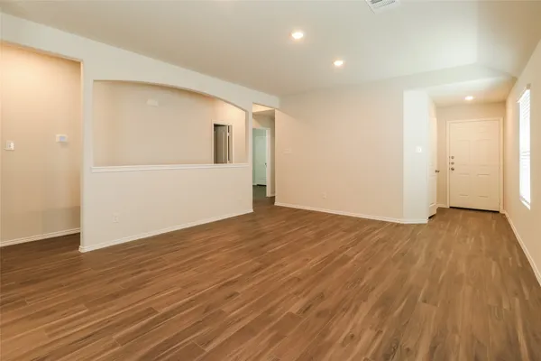 a view of a room with wooden floor and doors