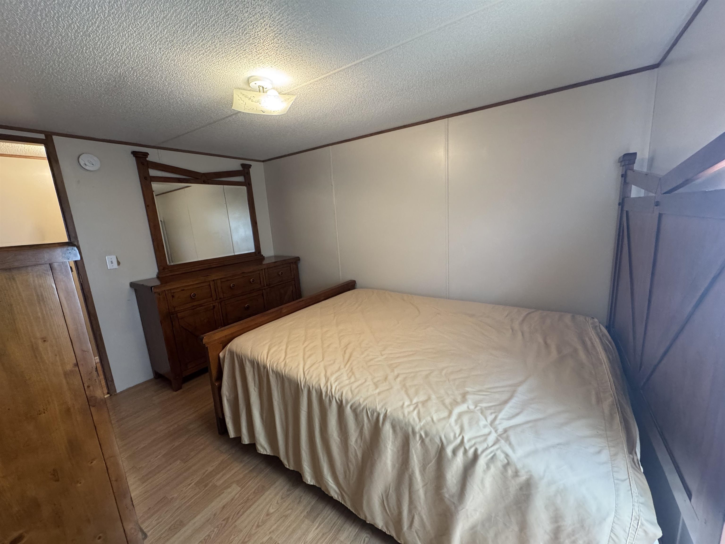 2511 Watkins Road Michie, TN 38357 - Photo 24 of 40 Wood-finish flooring with light-toned wall panels and dark trim