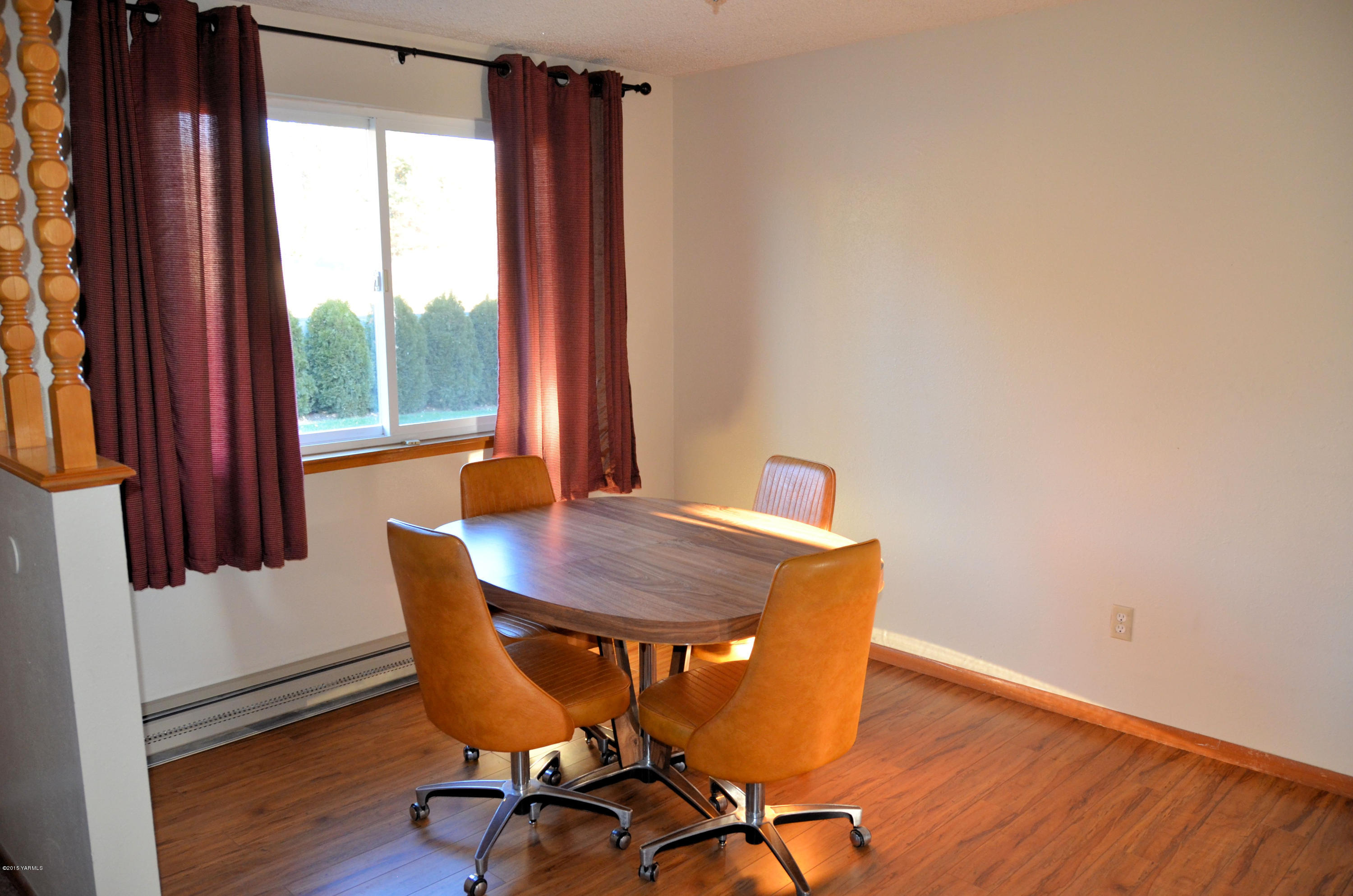 10814 Summitview Road Yakima, WA 98908 - Photo 11 of 16 a view of a dining room with furniture window and wooden floor