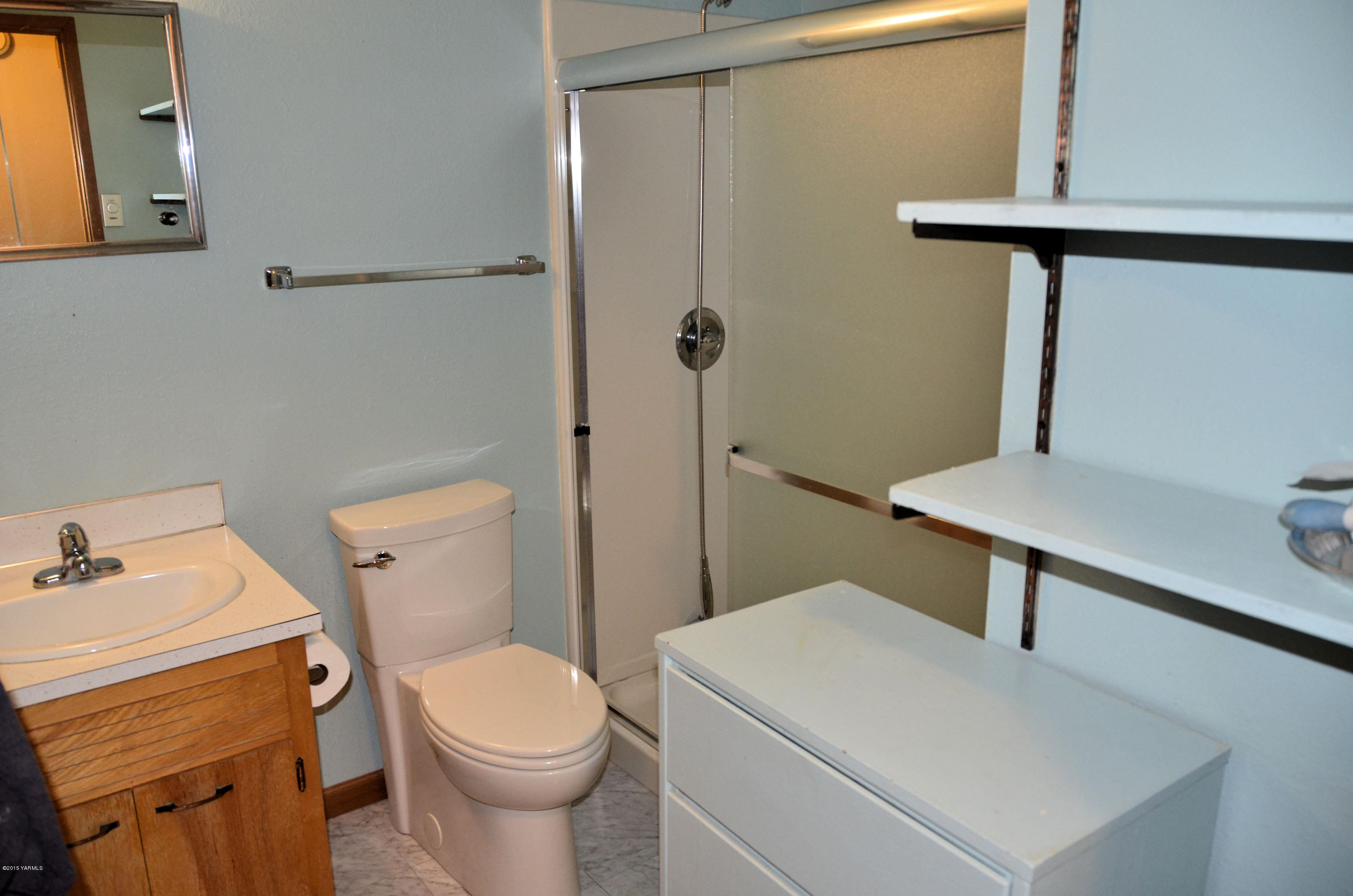 10814 Summitview Road Yakima, WA 98908 - Photo 12 of 16 a white toilet sitting next to a bathroom sink