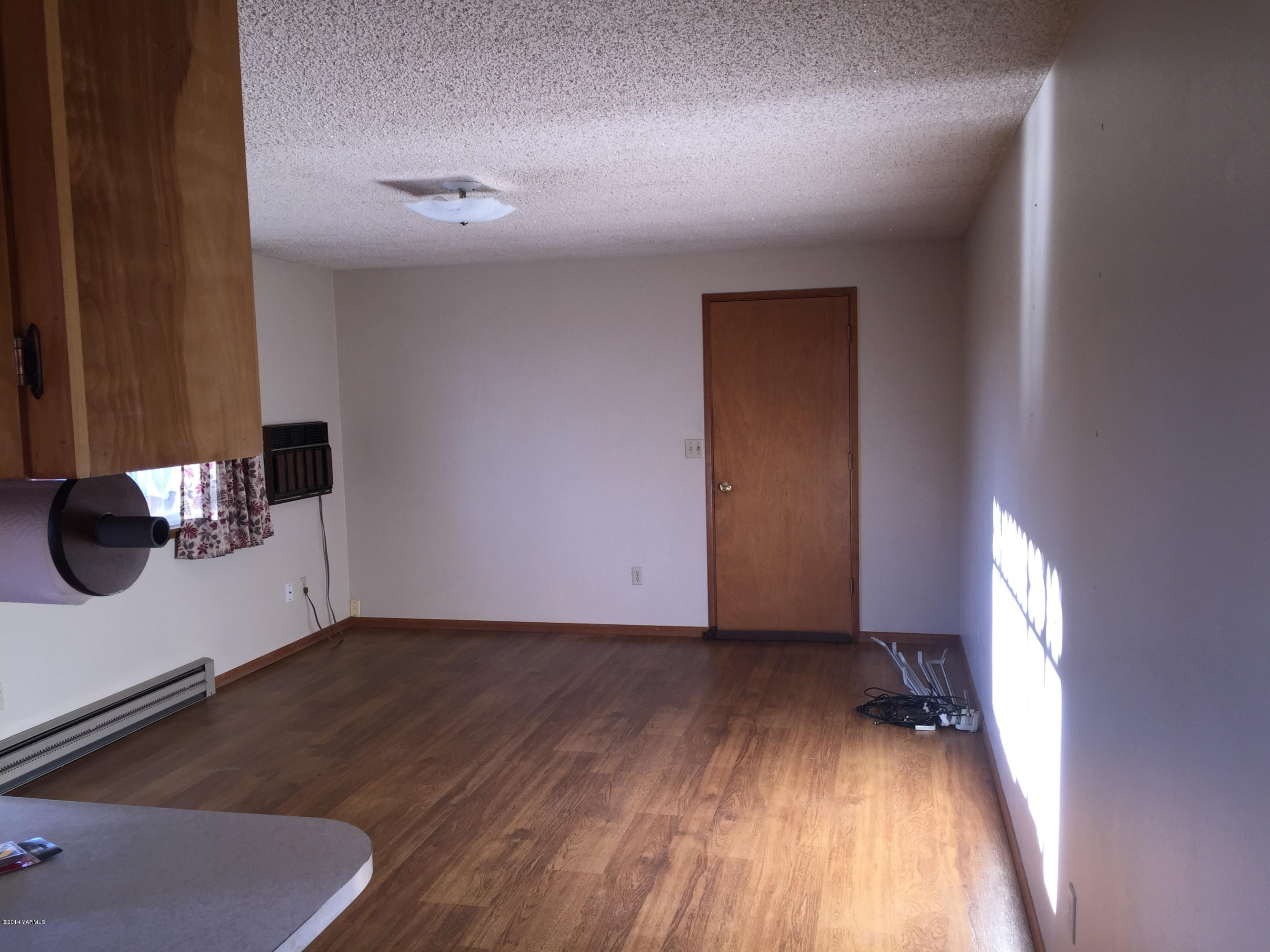 10814 Summitview Road Yakima, WA 98908 - Photo 4 of 16 wooden floor in an empty room with a window