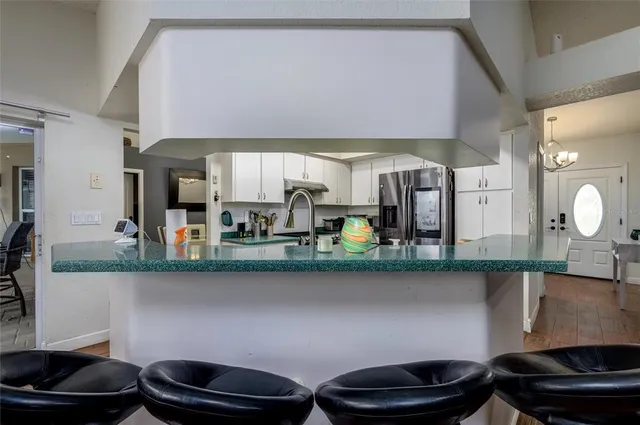 a kitchen with stainless steel appliances granite countertop a sink and a stove