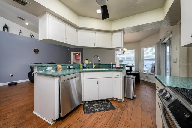 a kitchen with granite countertop white cabinets and white appliances