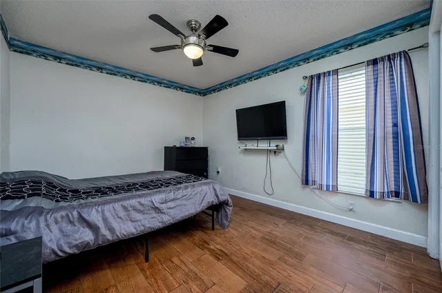 a bedroom with bed and flat screen tv
