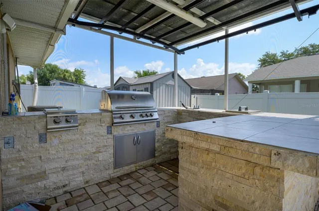 a open kitchen with stainless steel appliances granite countertop a sink and cabinets