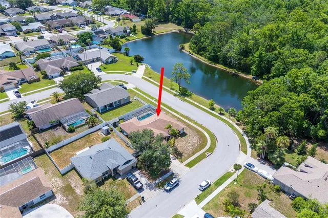 an aerial view of residential house with outdoor space and swimming pool
