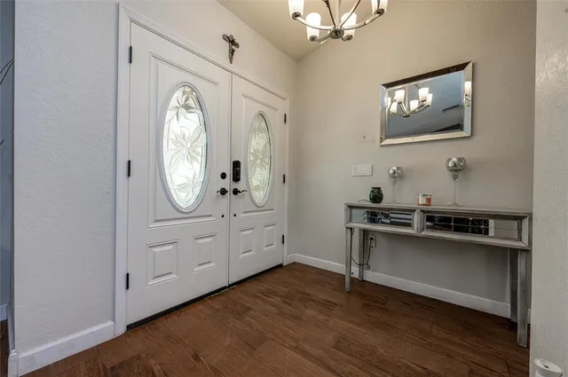 a view of a livingroom with furniture and mirror wooden floor