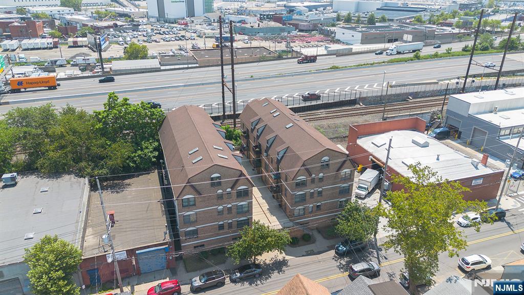 63-69 Rome Street, Unit 5K Newark, NJ 07105 - Photo 2 of 11 a view of a building with a couple of cars parked in parking lot