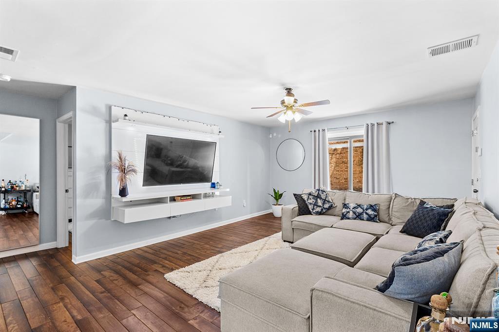 63-69 Rome Street, Unit 5K Newark, NJ 07105 - Photo 4 of 11 a living room with furniture and a flat screen tv