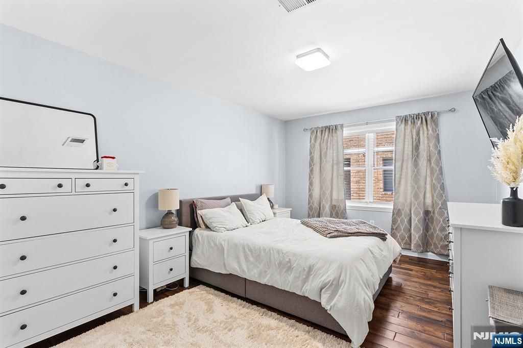 63-69 Rome Street, Unit 5K Newark, NJ 07105 - Photo 6 of 11 a bedroom with a bed and window