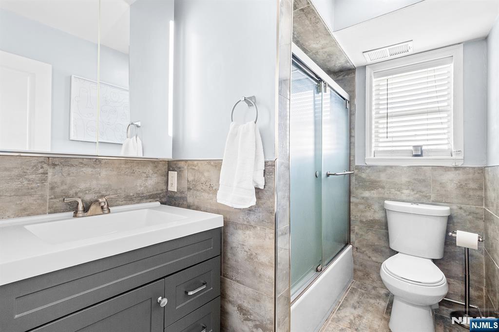 63-69 Rome Street, Unit 5K Newark, NJ 07105 - Photo 9 of 11 a bathroom with a sink toilet and shower