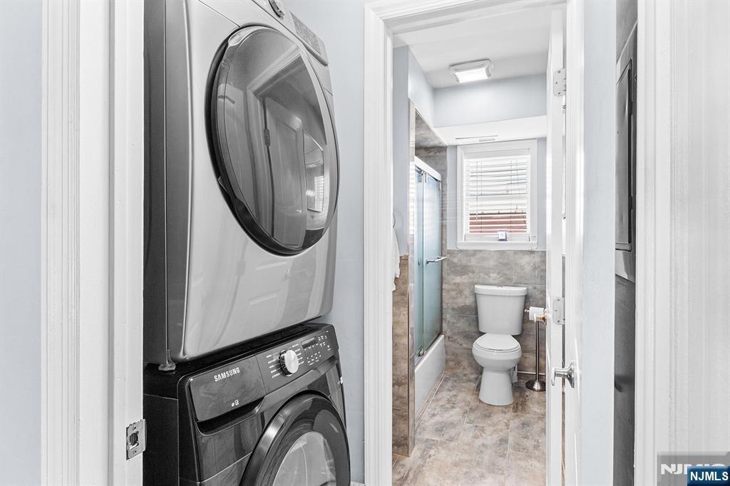 63-69 Rome Street, Unit 5K Newark, NJ 07105 - Photo 10 of 11 a bathroom with a toilet and a mirror