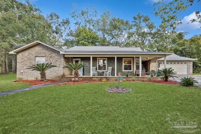 a view of a house with a yard porch and sitting area