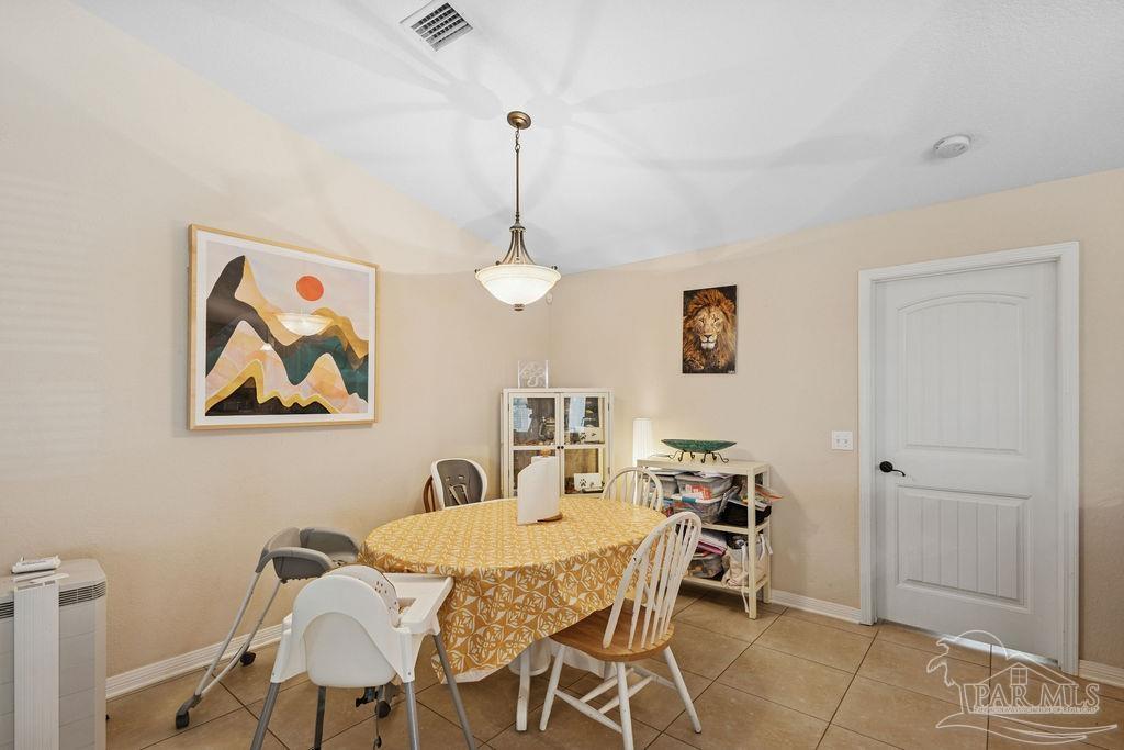 8240 Tidwell Road Pace, FL 32571 - Photo 13 of 41 a dining room with furniture and window