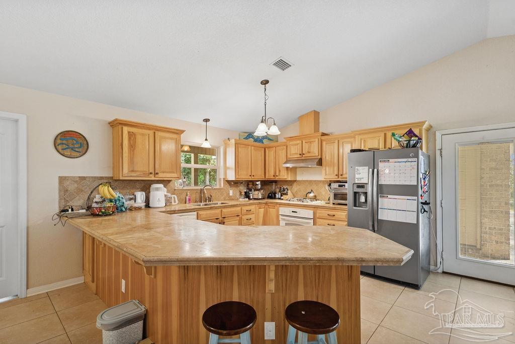 8240 Tidwell Road Pace, FL 32571 - Photo 14 of 41 a kitchen with a table and chairs