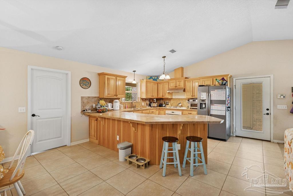 8240 Tidwell Road Pace, FL 32571 - Photo 16 of 41 a large kitchen with a table and chairs