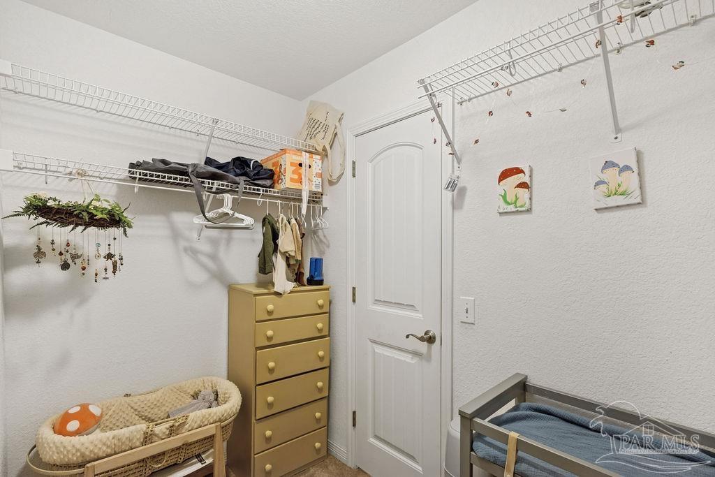 8240 Tidwell Road Pace, FL 32571 - Photo 17 of 41 a view of walk in closet