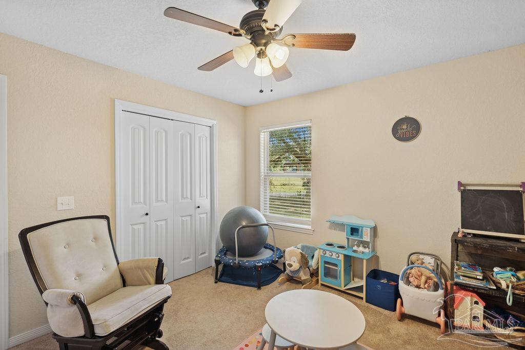 8240 Tidwell Road Pace, FL 32571 - Photo 19 of 41 a living room with furniture a fireplace and a window