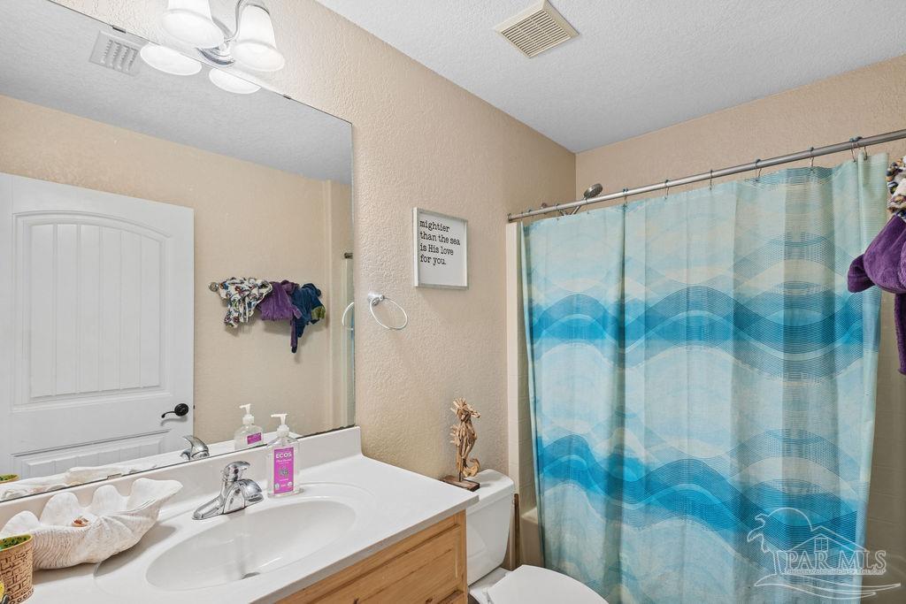 8240 Tidwell Road Pace, FL 32571 - Photo 20 of 41 a bathroom with a sink vanity mirror and toilet