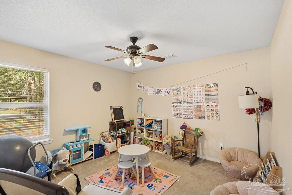 8240 Tidwell Road Pace, FL 32571 - Photo 21 of 41 a living room with furniture and a large window