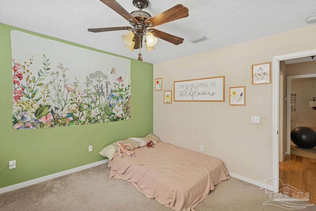 8240 Tidwell Road Pace, FL 32571 - Photo 22 of 41 a bedroom with a bed and the wall painting