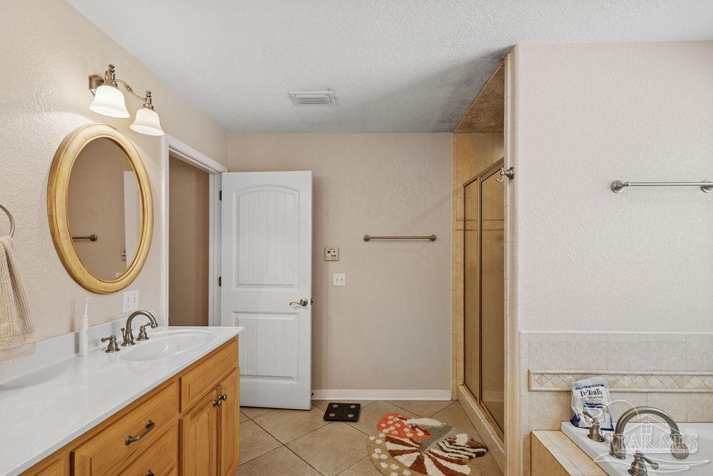8240 Tidwell Road Pace, FL 32571 - Photo 27 of 41 a bathroom with a granite countertop sink toilet and shower