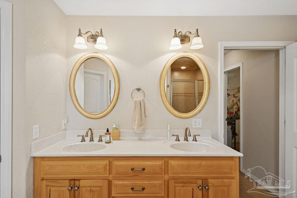 8240 Tidwell Road Pace, FL 32571 - Photo 28 of 41 a bathroom with a sink and a mirror